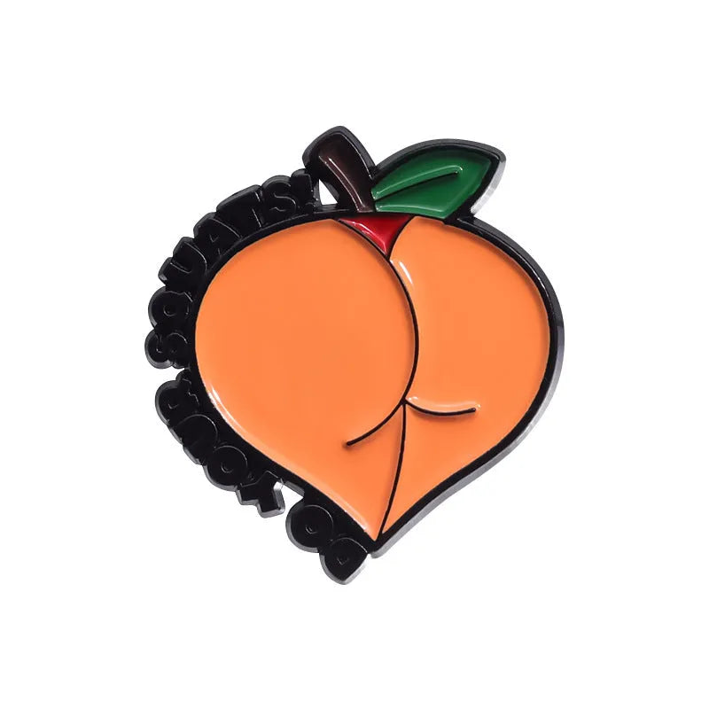 Colourful cartoon fruit design metal brooch pin on a fabric background.