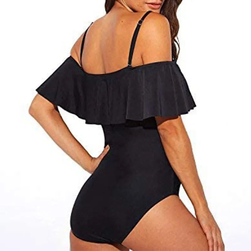 Black one-piece swimsuit with cut-out design and ruffled strap tube top