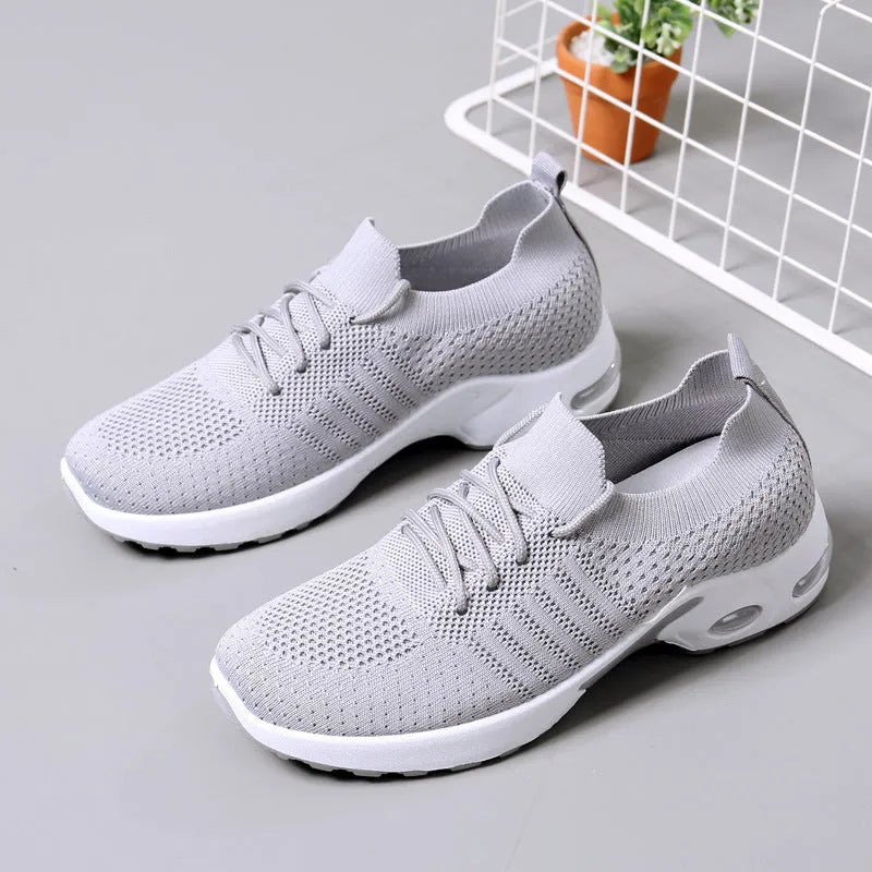 Women's black mesh casual sneaker with round toe and white non-slip PVC sole, shown from the side.