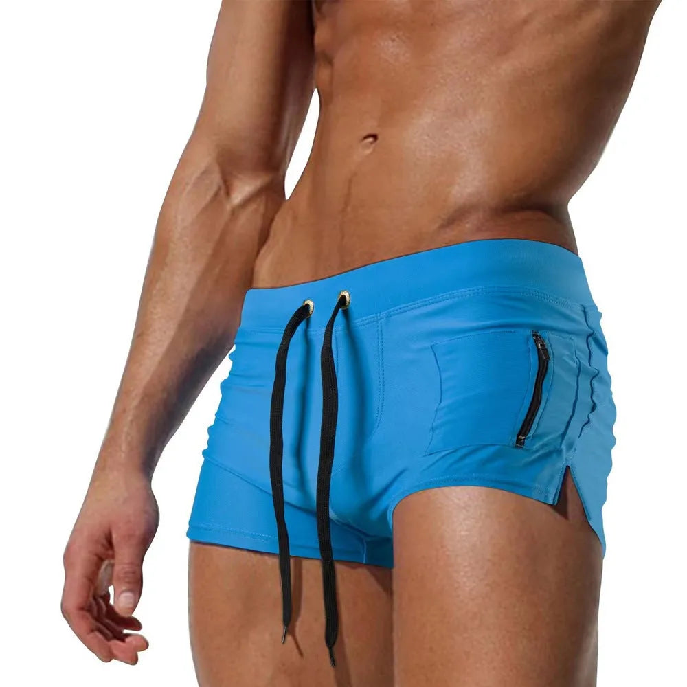 Men's black high-waist polyester swimming trunks with lace-up detail and spandex lining