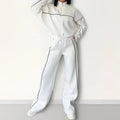 Casual two-piece suit set with a grey hoodie and striped lace-up trousers on a hanger