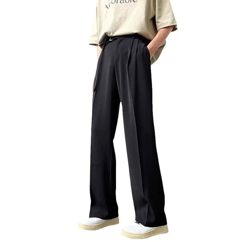 A pair of thin, black wide leg trousers with a straight cut and loose fit, laid flat.