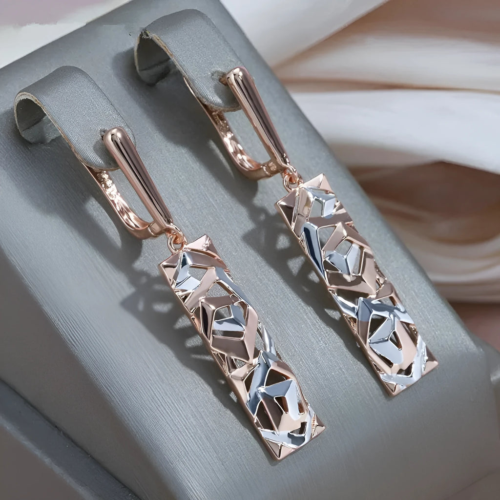 Close-up of women's rectangular hollow two-tone alloy stud earrings on a white background.