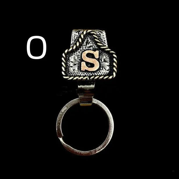 Handmade metal cow tag belt key holder keychain on a key ring, showing the metal loop and tag design.
