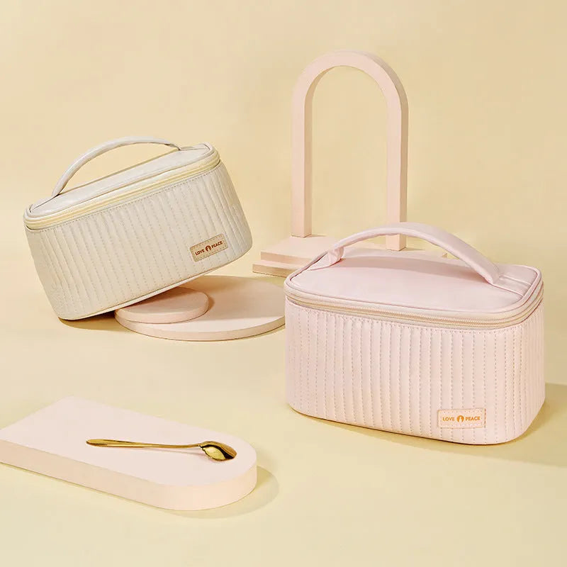 Open-top pink PU leather cake-style makeup bag on a table