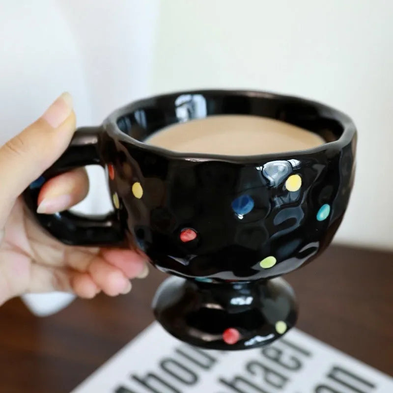 Hand-pinched irregular ceramic mug in a solid colour, showing unique handmade shape.