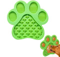 Blue silicone dog licking mat with bone texture and suction cups on the back, placed on a tiled wall.