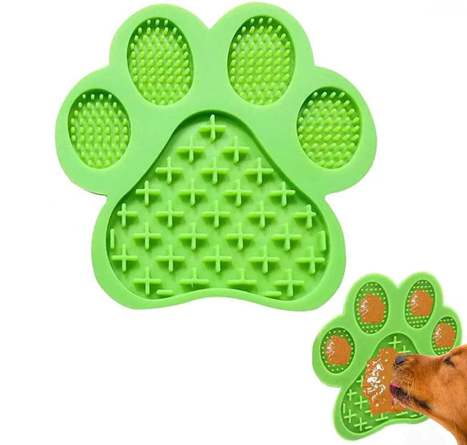 Blue silicone dog licking mat with bone texture and suction cups on the back, placed on a tiled wall.