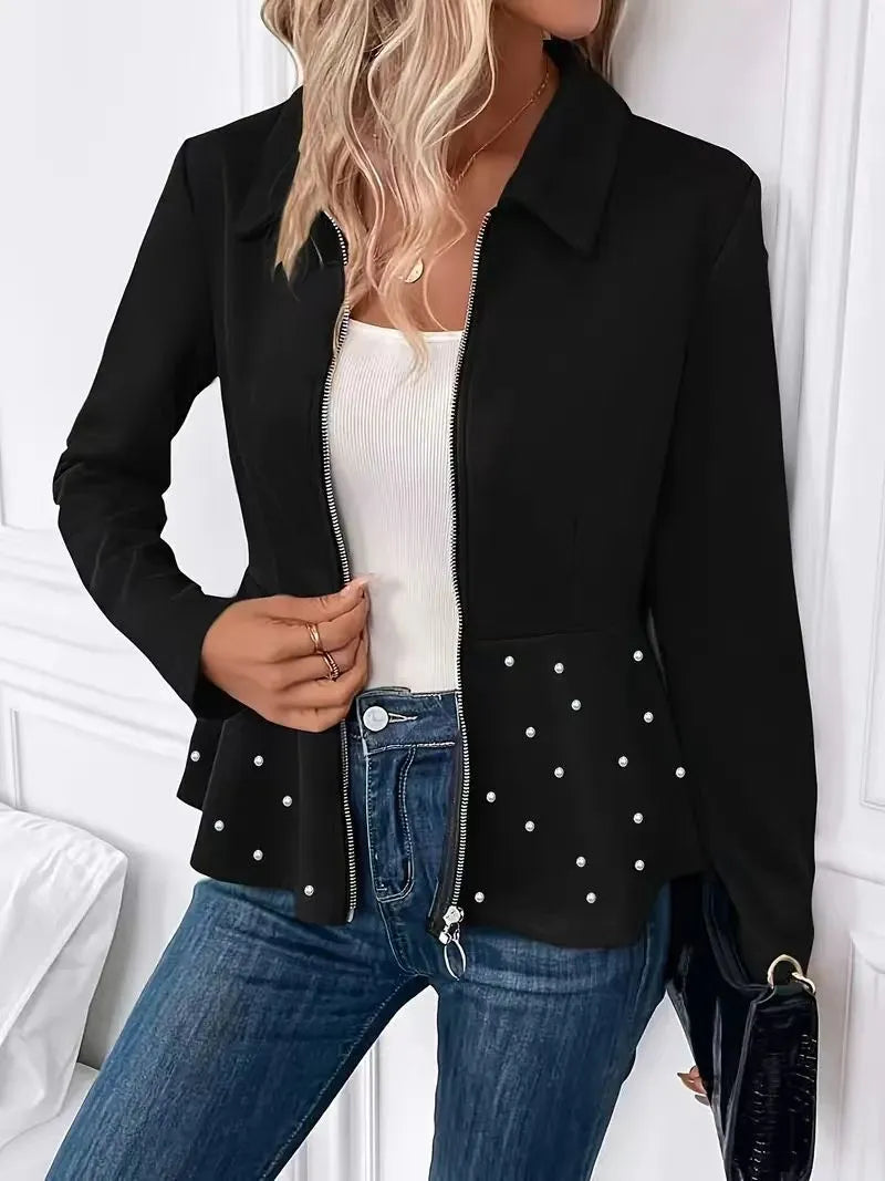 Women's black loose fit coat with beaded zipper and ruffle hem on a hanger.
