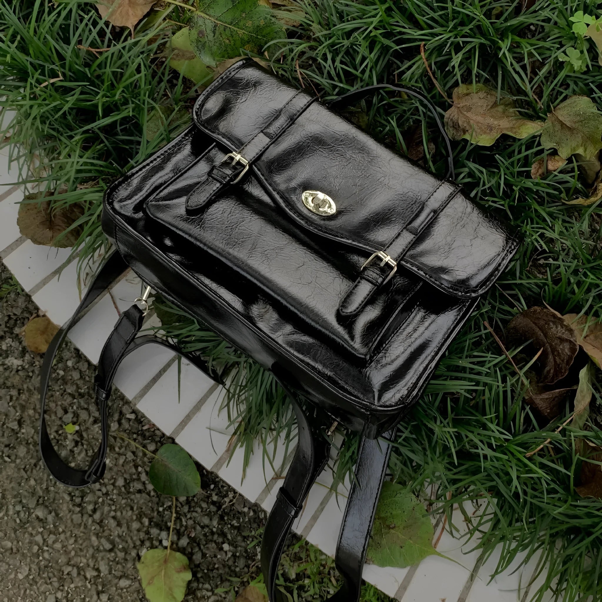 Black women's messenger bag with oil wax leather finish and adjustable crossbody strap