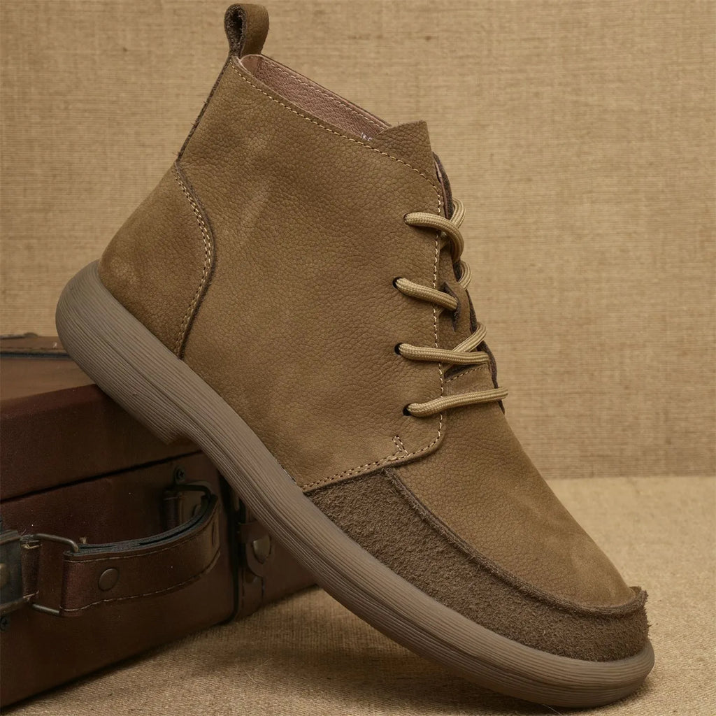 Grey genuine leather martin boots with wedge heel and front lace-up fastening on a neutral background