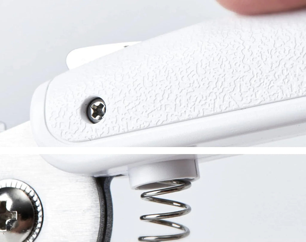 White pet nail clippers with LED light, open transparent splash guard, and separate nail file on a table
