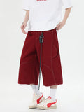 Retro denim workwear shorts with multiple pockets and wide leg trousers styling in black or red