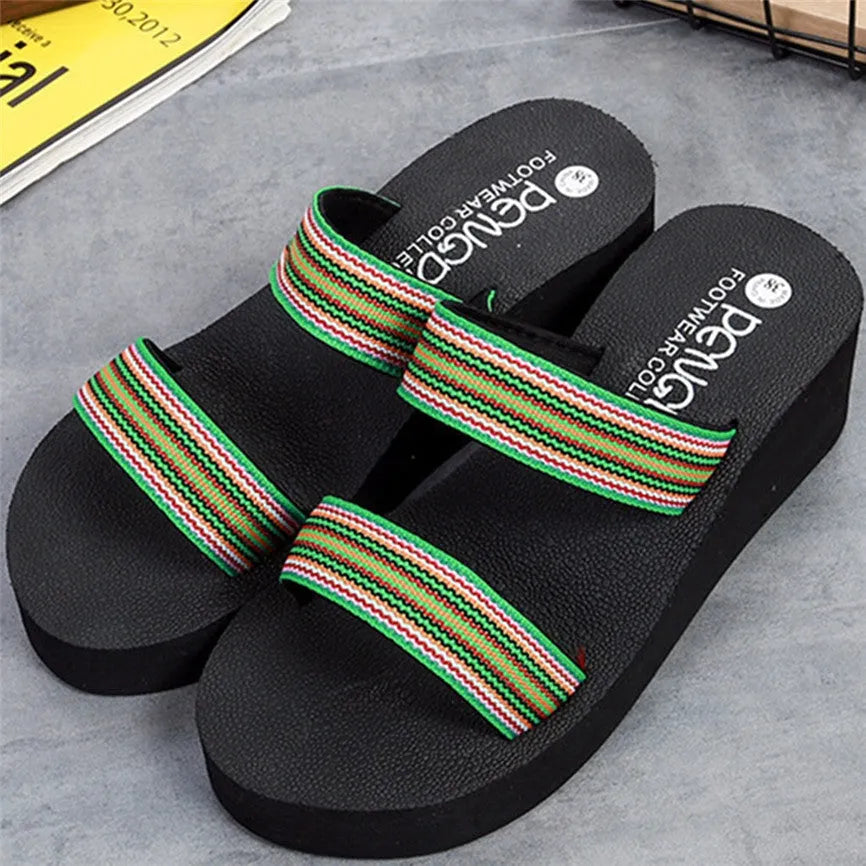 Brown women's bohemian summer slippers with elastic strap on a wooden deck.
