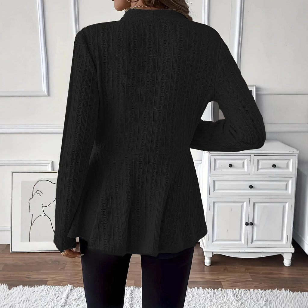 Women's apricot coloured knitted cardigan with jacquard pattern and one button, shown on a model.