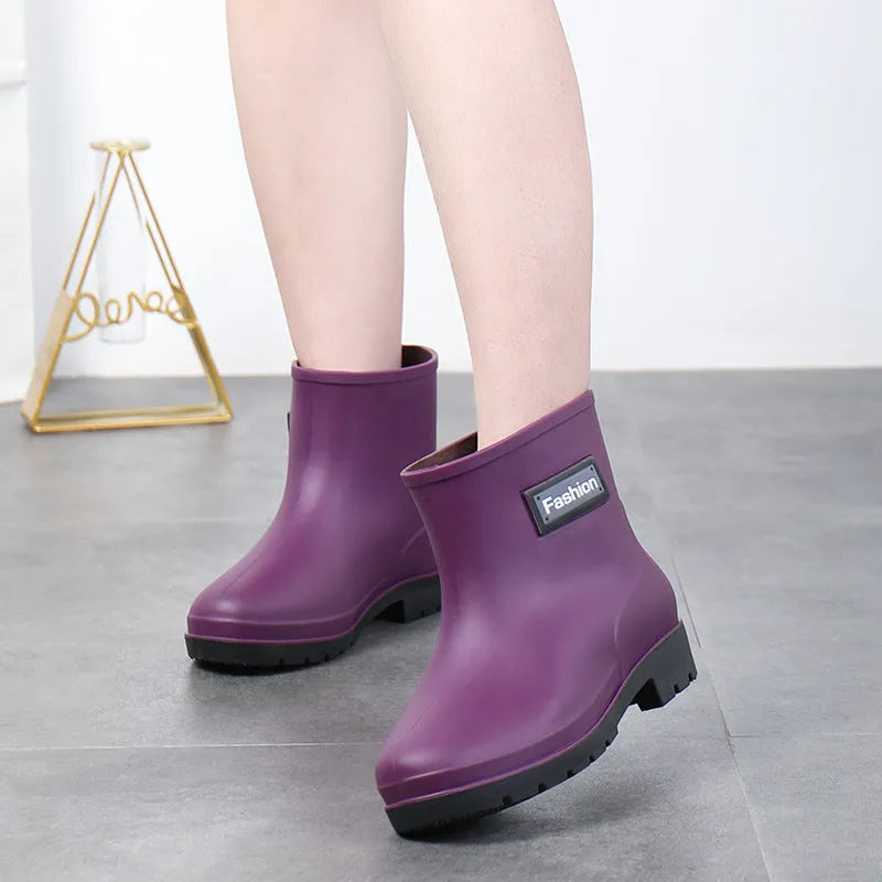 Women's black PVC rain boots with mid-calf height and low heel