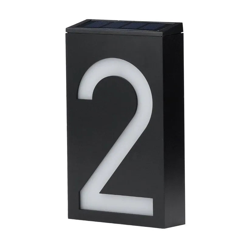 Solar-powered white LED house number light mounted on an outdoor wall