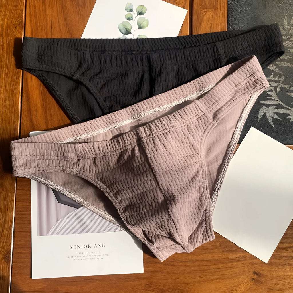 Men's solid colour cotton briefs with mid waist and triangle style in apricot black and skin colour.