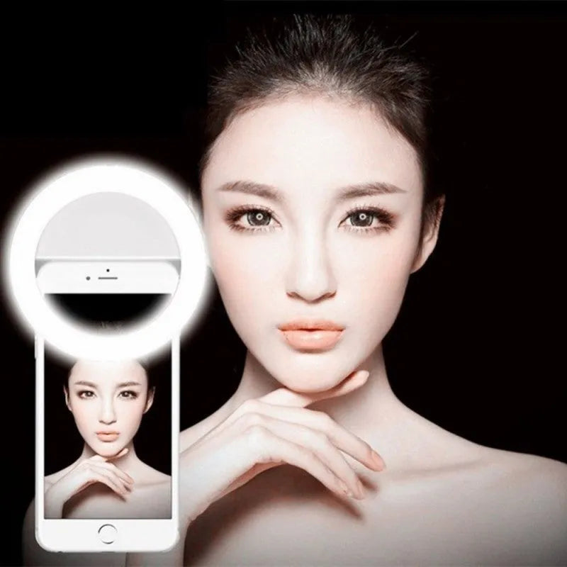Green selfie ring light clipped to smartphone showing LED bulbs for photography lighting