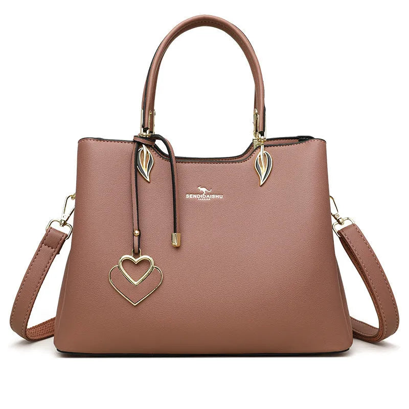 Women's black PU messenger bag with multi-layer design and visible sewing thread detail.