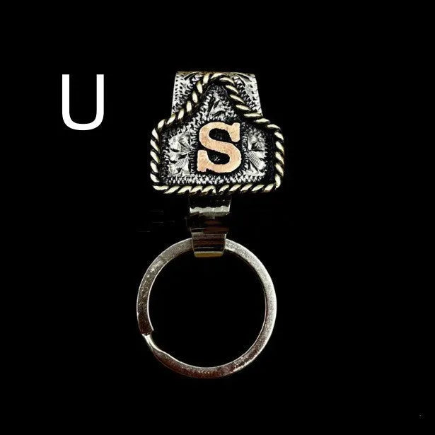 Handmade metal cow tag belt key holder keychain on a key ring, showing the metal loop and tag design.
