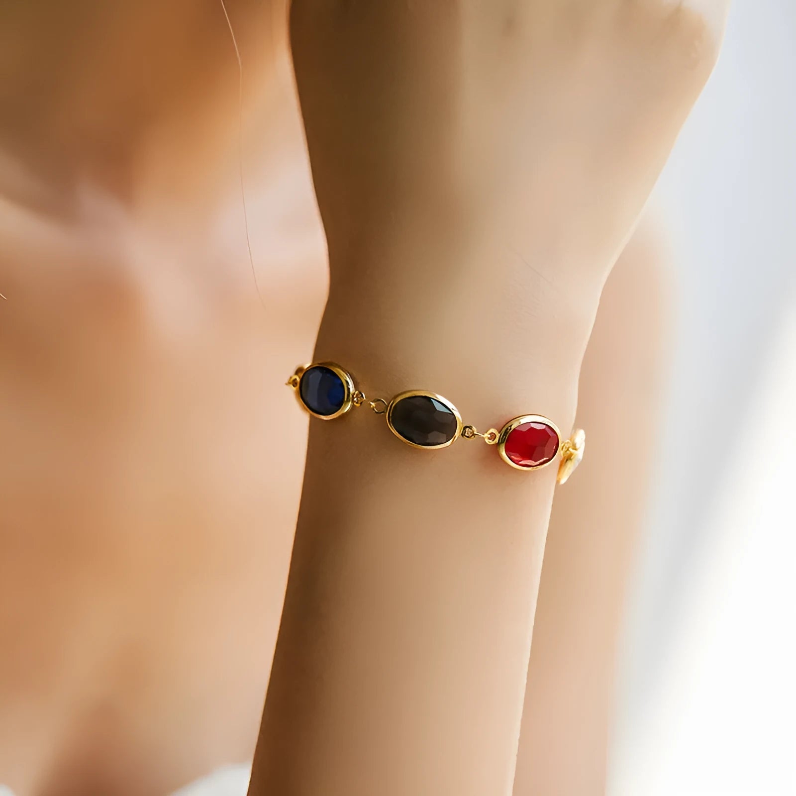 Women's 18K copper geometric ellipse bracelet with blue green multicolor glass inlay detailing