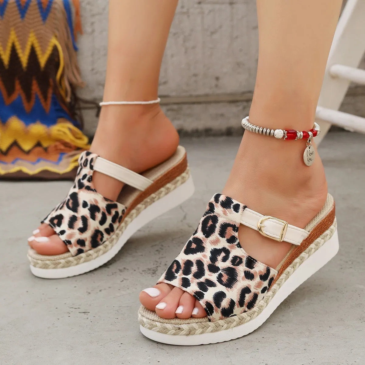 Leopard print women's platform sandals with a wedge sole and fish-mouth toe.