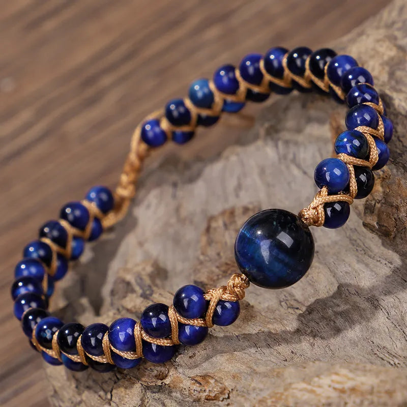 Handmade woven geometric bracelet with a blue Tigereye stone bead and pull design.