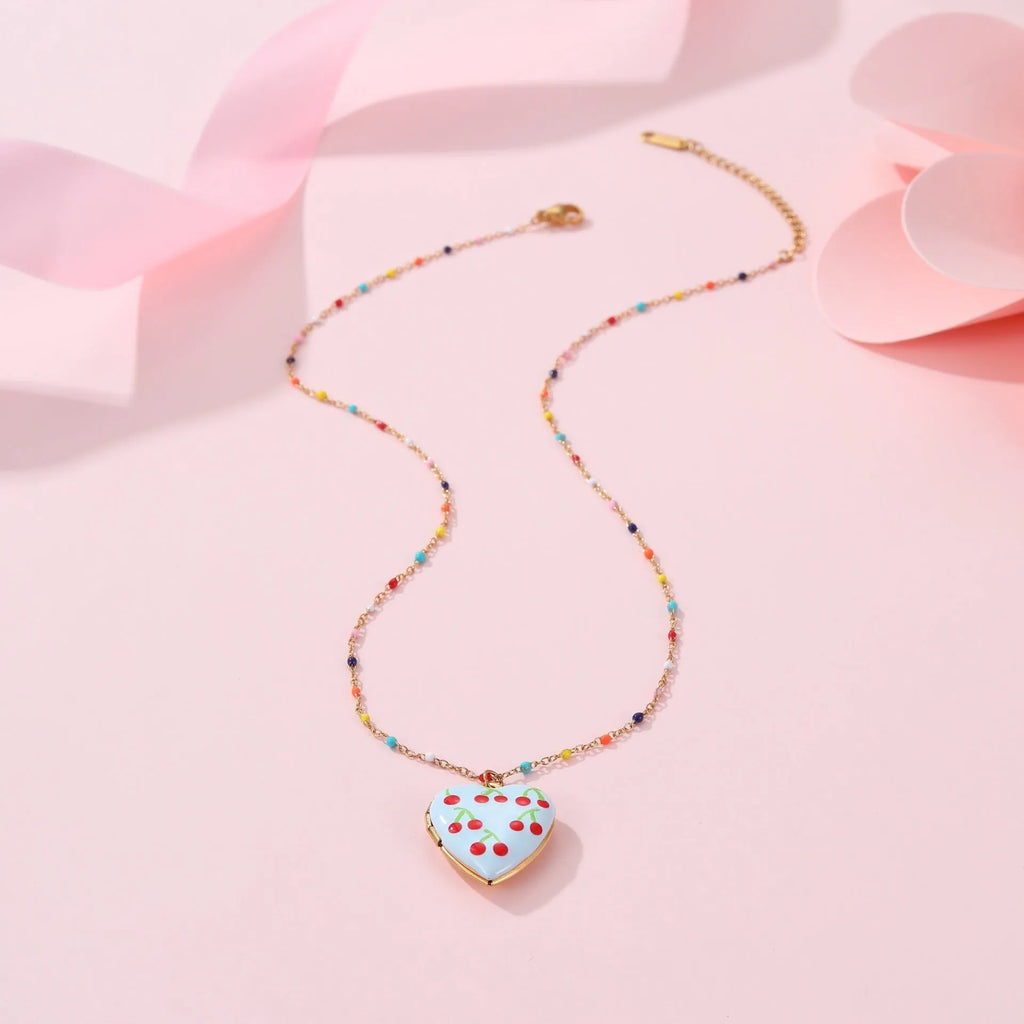 Women's stainless steel necklace with gold plating showing heart-shaped fruit pendant design on adjustable chain