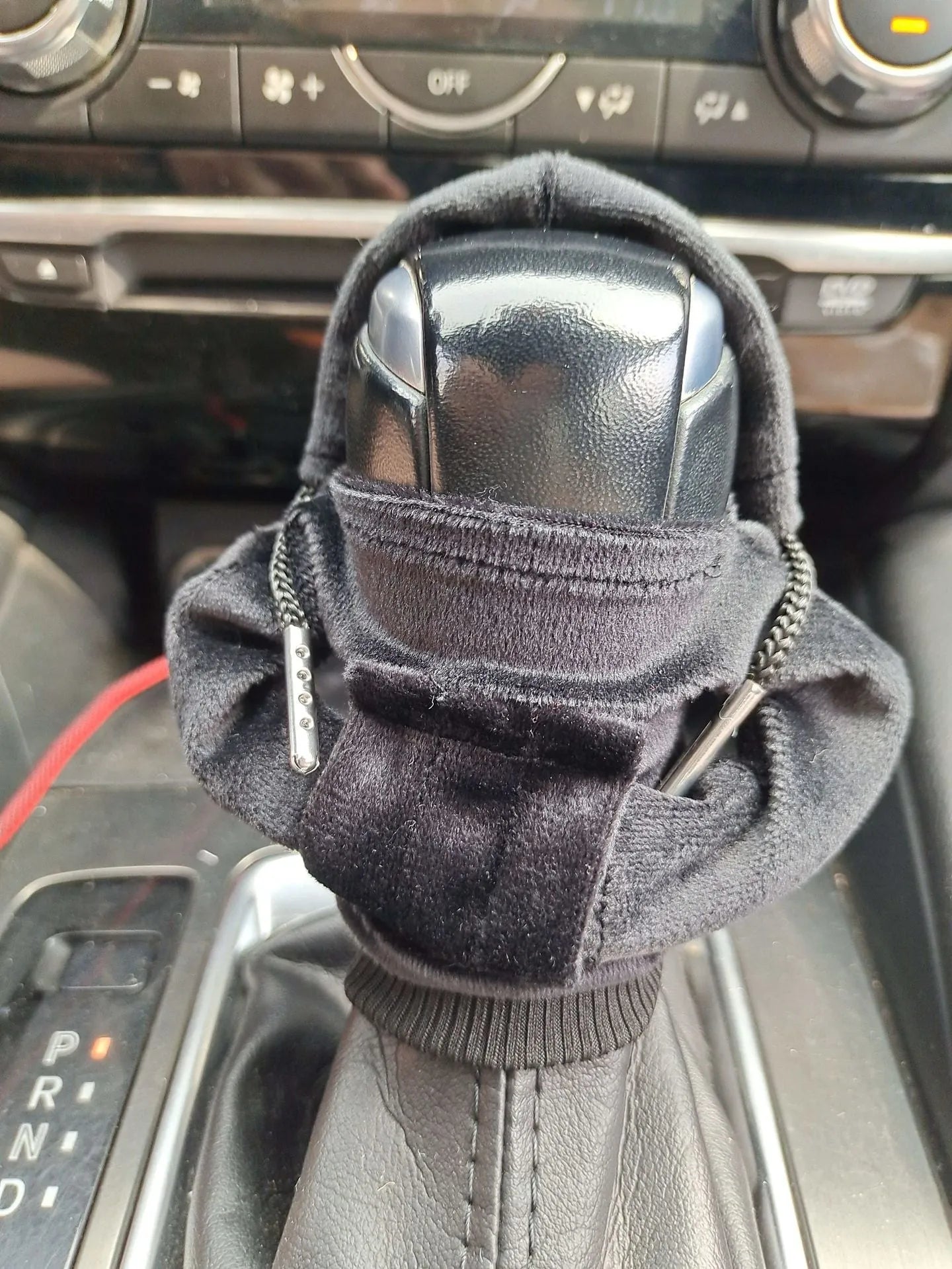 Pure cotton car gear lever sweater decoration in multiple colours on a gear stick.