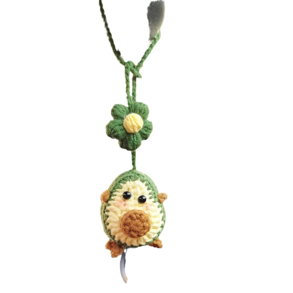 Handmade crocheted wool car pendant in avocado, pink rainbow, or red rainbow colours with cartoon styling