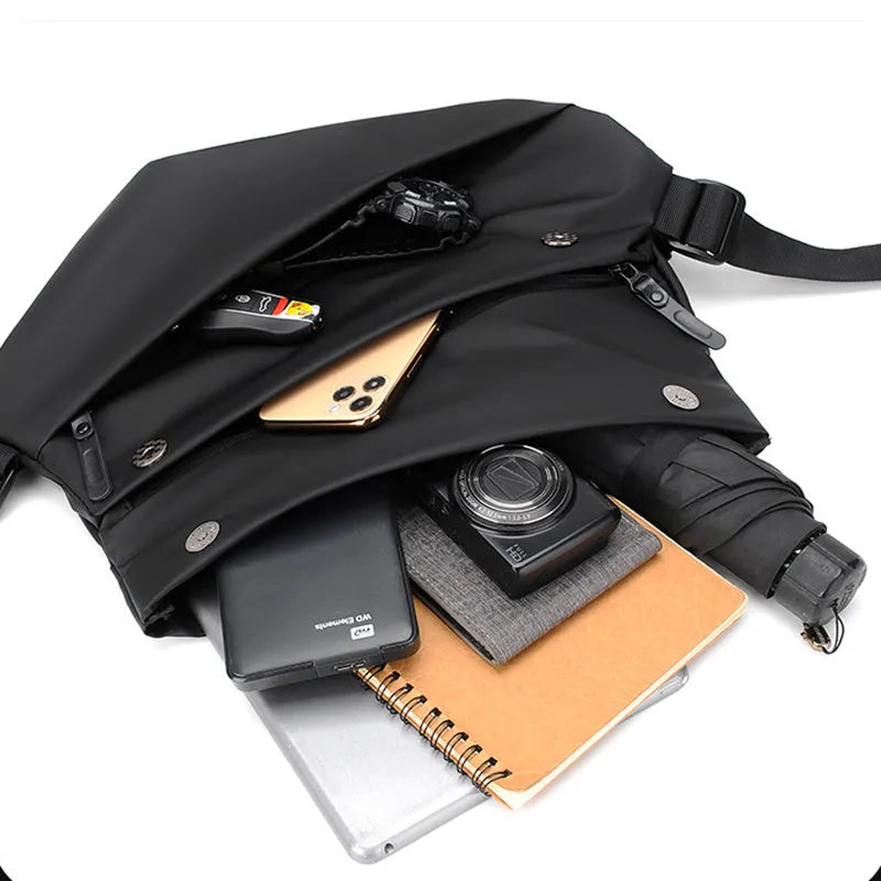 Men's grey crossbody bag showing internal phone pocket and document compartment with shoulder strap