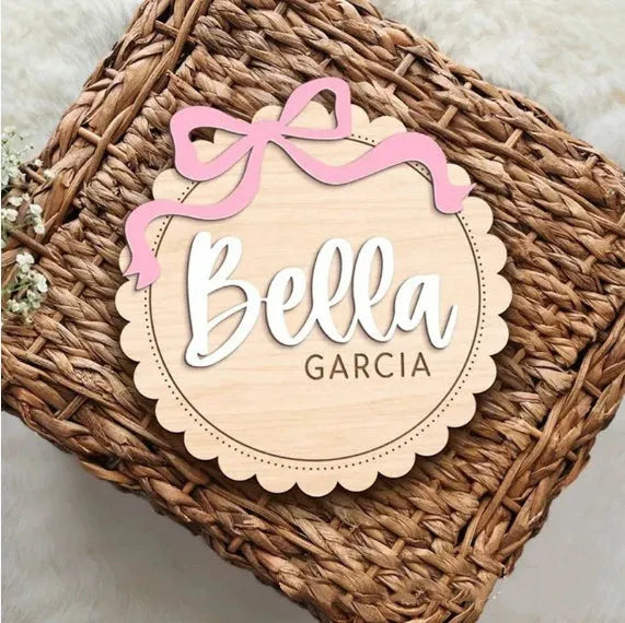 Square wooden baby room ornament with a custom engraved name, shown in two size options.