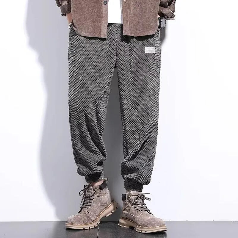 Men's grey straight-leg casual sweatpants with an ankle-tied design on a white background.