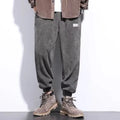 Men's grey straight-leg casual sweatpants with an ankle-tied design on a white background.