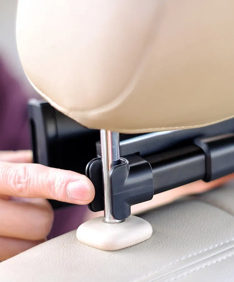 Black car phone holder mounted on vehicle rear seat base with tablet device secured in place