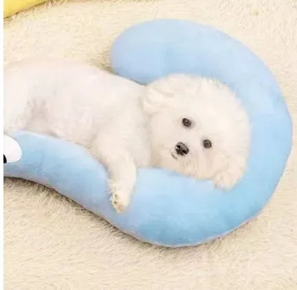 Blue moon-shaped and yellow question mark-shaped cloth pillows for cats, showing U-shaped neck support design.