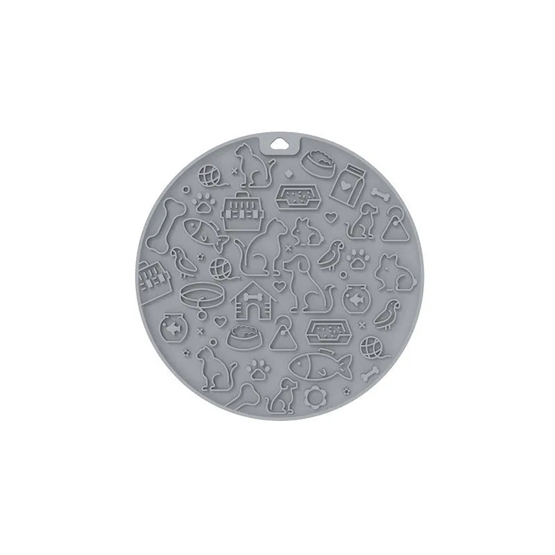 Round silicone pet licking mat with suction cup base in blue colour on smooth surface