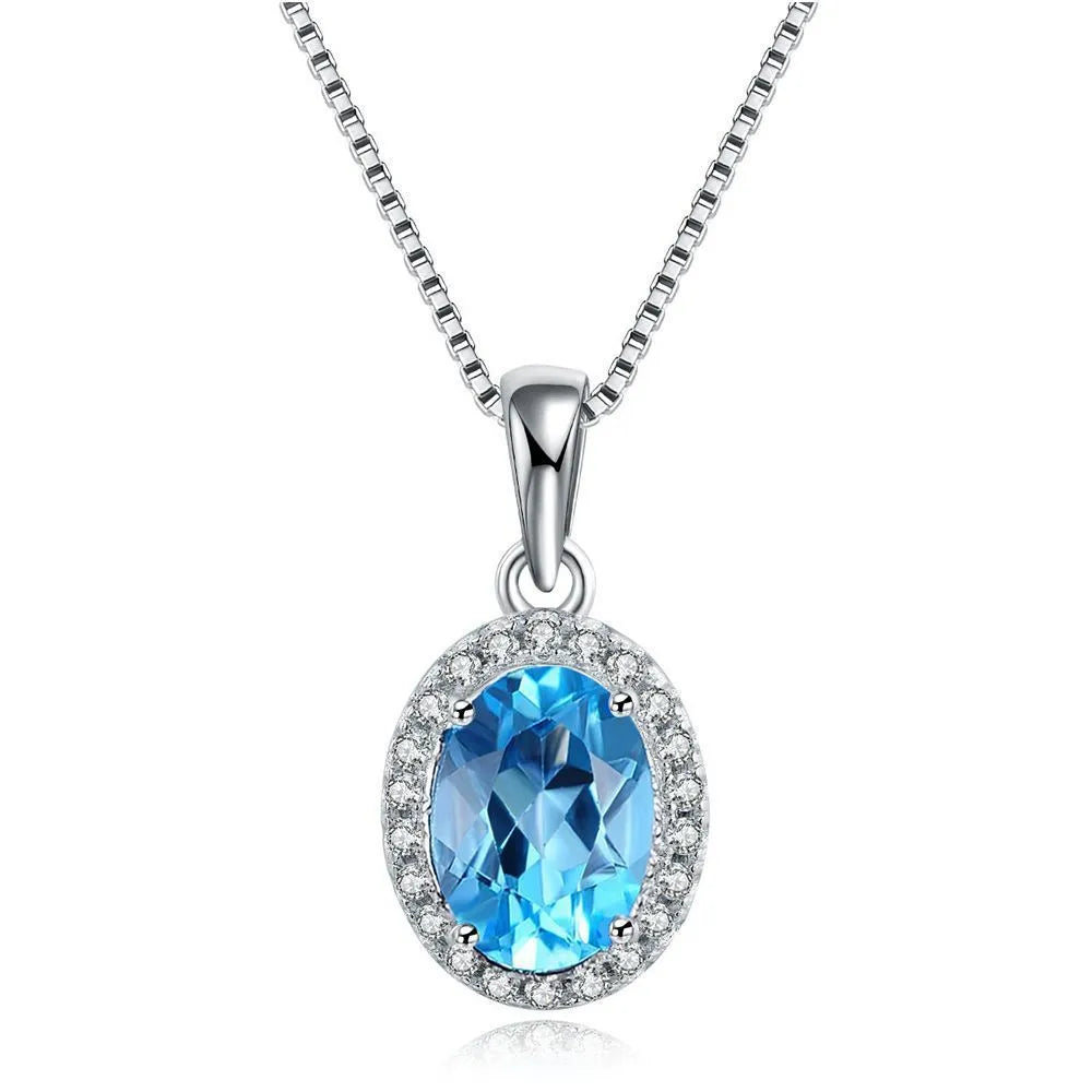 Women's 925 sterling silver jewellery set with blue topaz gemstones showing earrings, ring, pendant, and necklace with geometric pattern