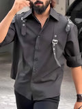 Men's black utility button-up shirt on a hanger showing button front and regular-length cut