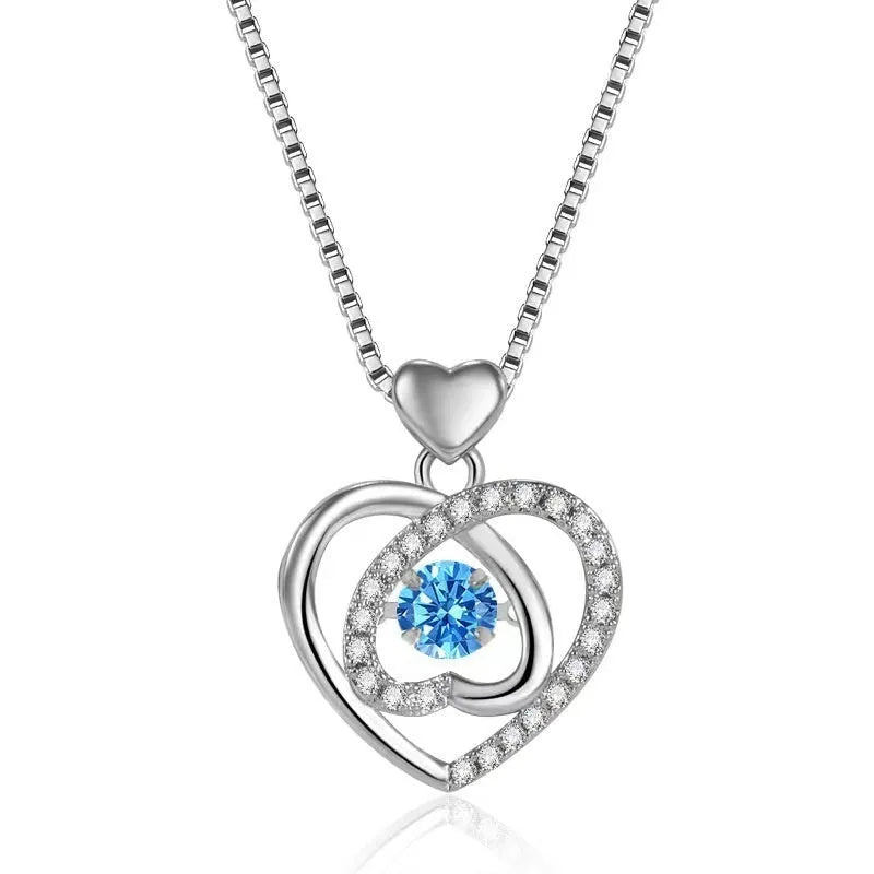 Blue diamond heart necklace and bracelet set with adjustable chain on display