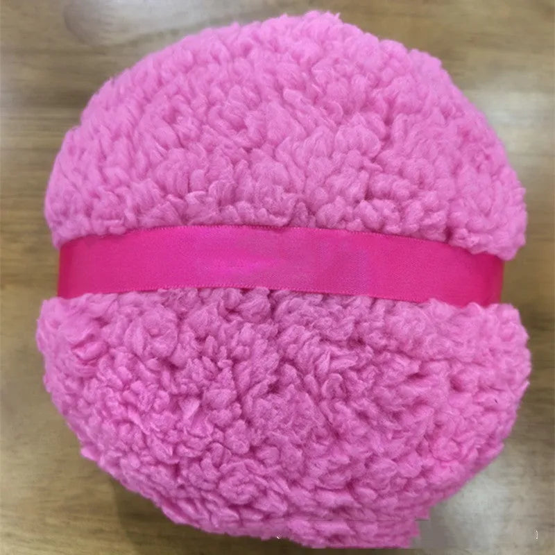 Oversized white plush powder puff measuring 150mm by 75mm for makeup application