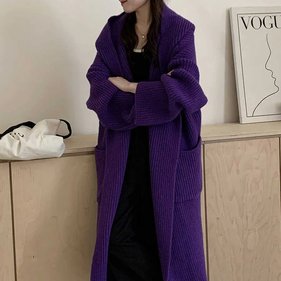 Loose hooded acrylic cardigan coat for women in beige, showing long length and raglan sleeves.