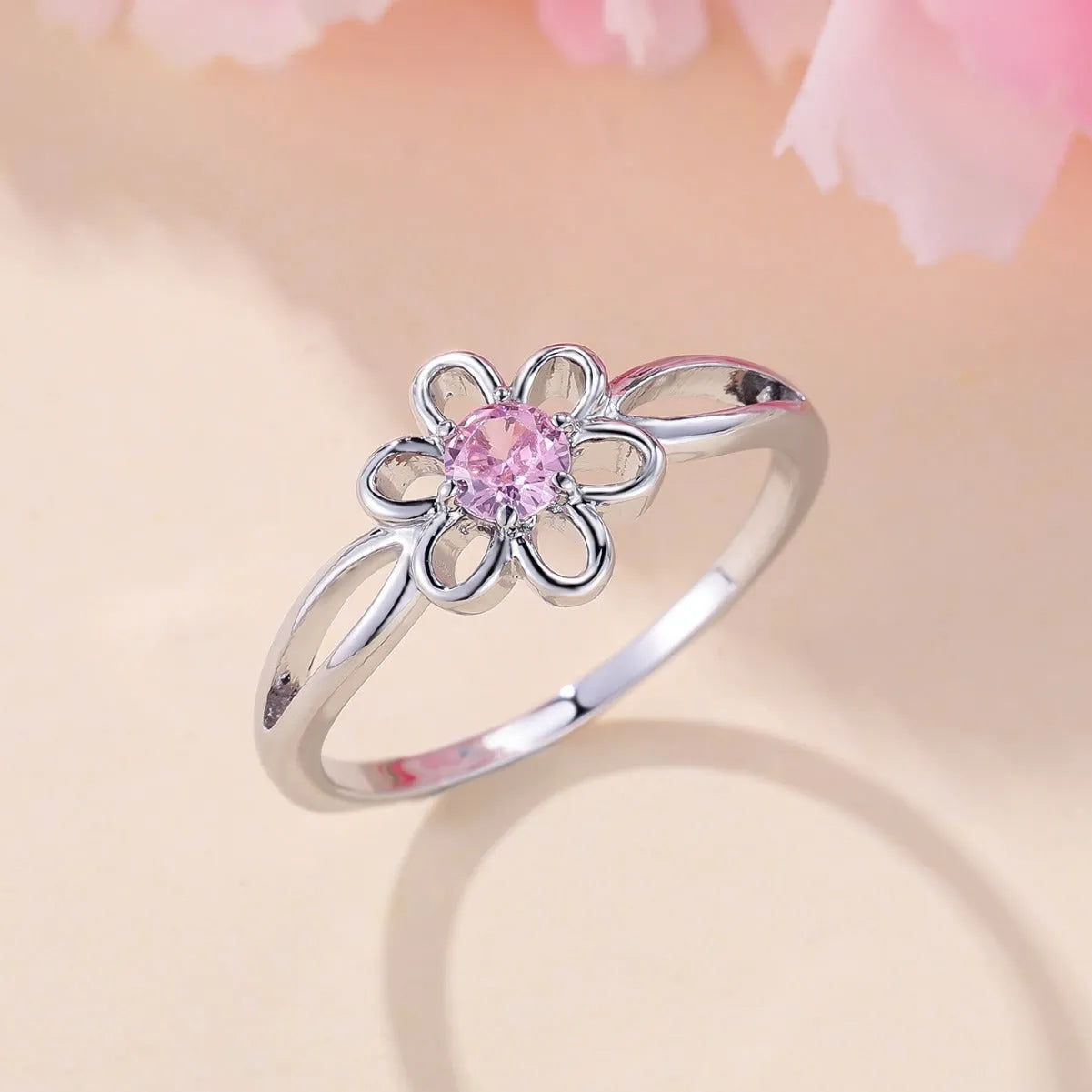 Copper flower hollow-out fashion ring for women with platinum pink diamond plating.