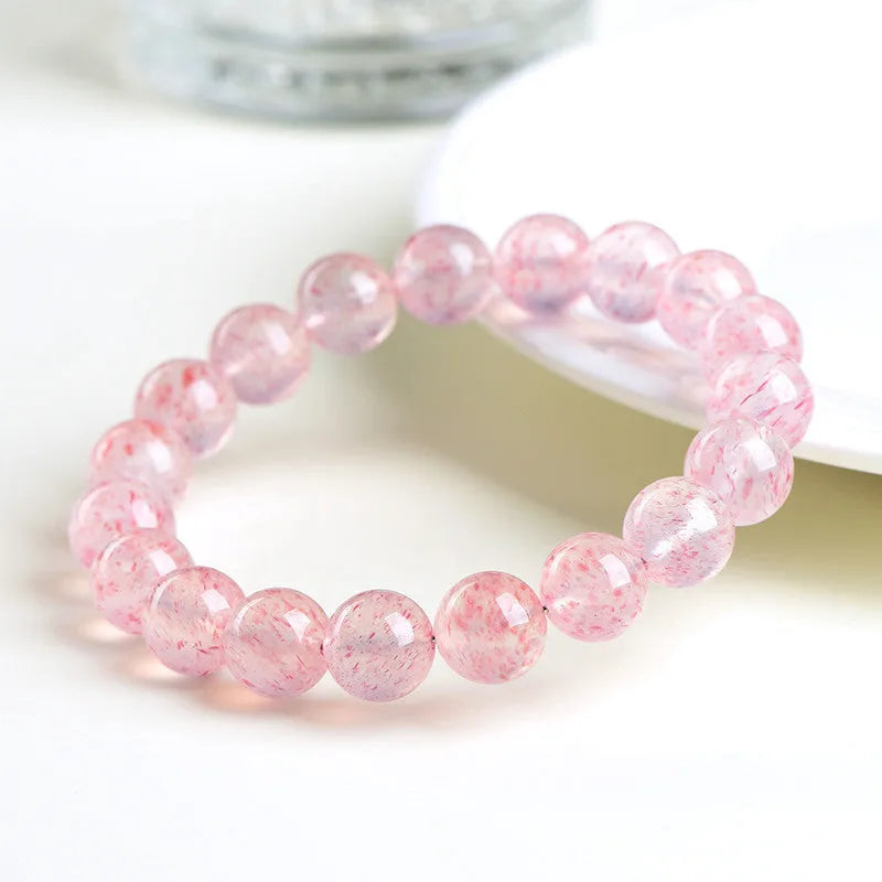 Natural white strawberry quartz crystal bracelet with 10-10.8mm polished beads on elastic cord