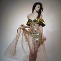 Gold sequined strapless long evening dress with a high split on the skirt, shown on a model.