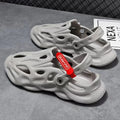 Men's grey EVA slippers with closed toe and breathable hole design on foot