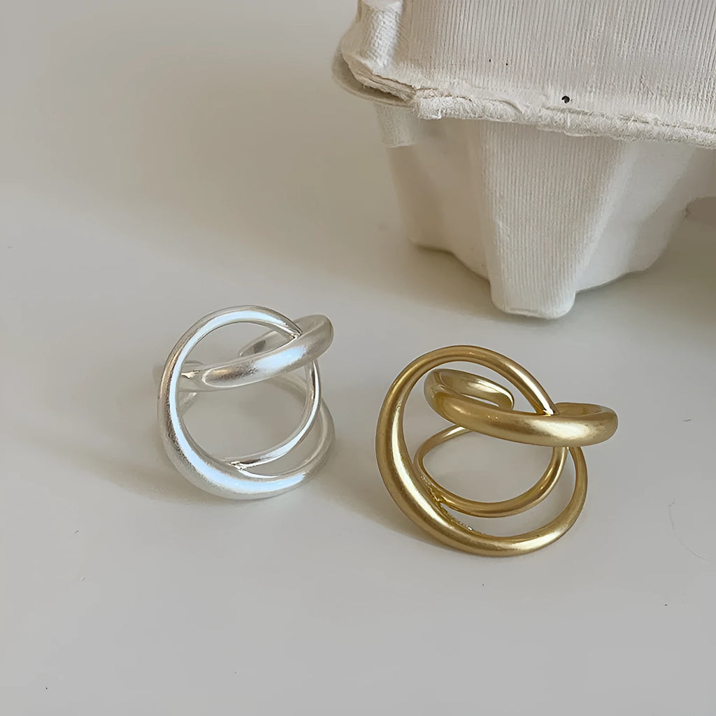 Geometric interlaced matte metal open ring for women in gold or silver.