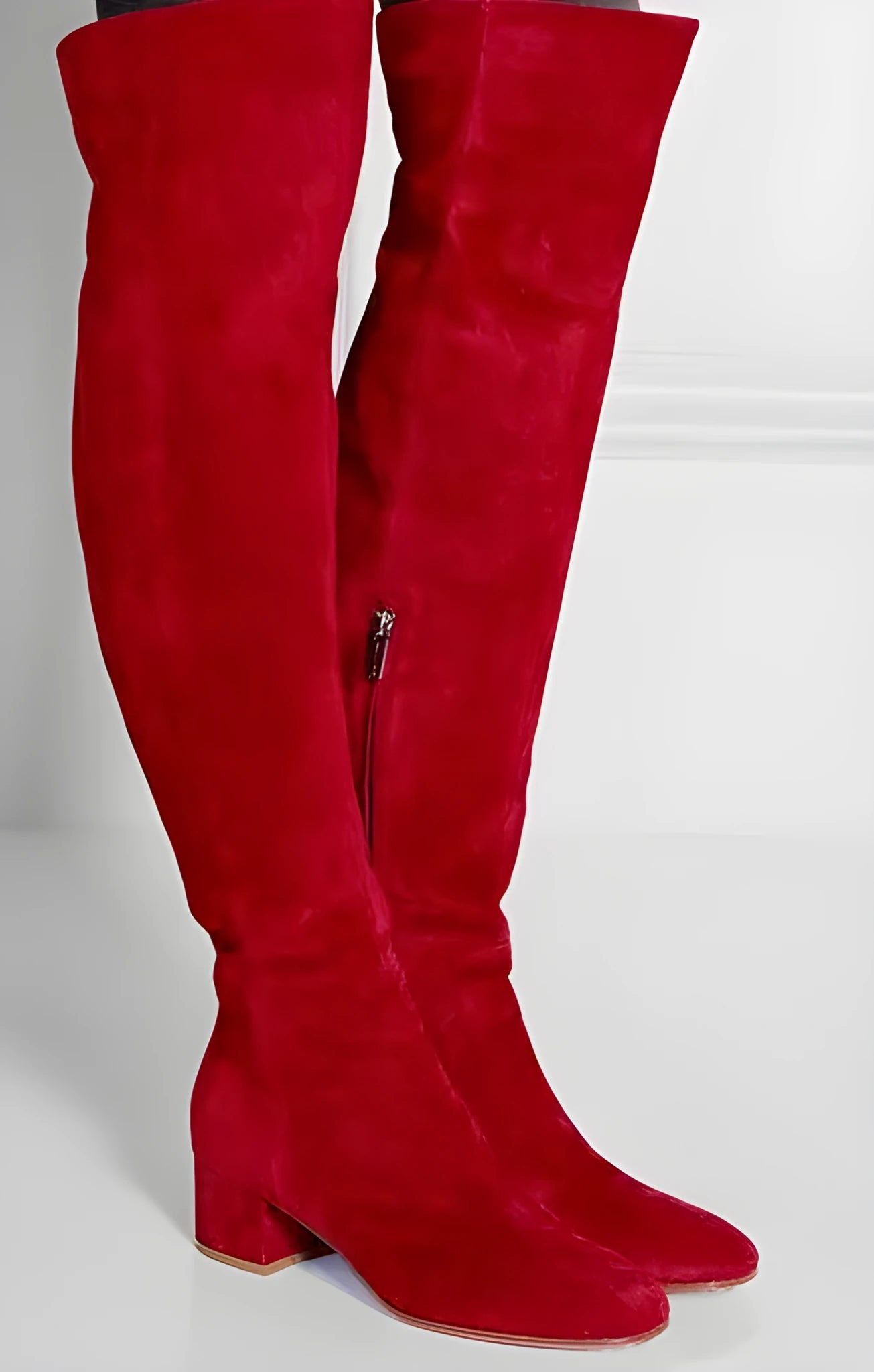 Women's grey suede over-the-knee flat boots with a pointed toe and thick low heel.
