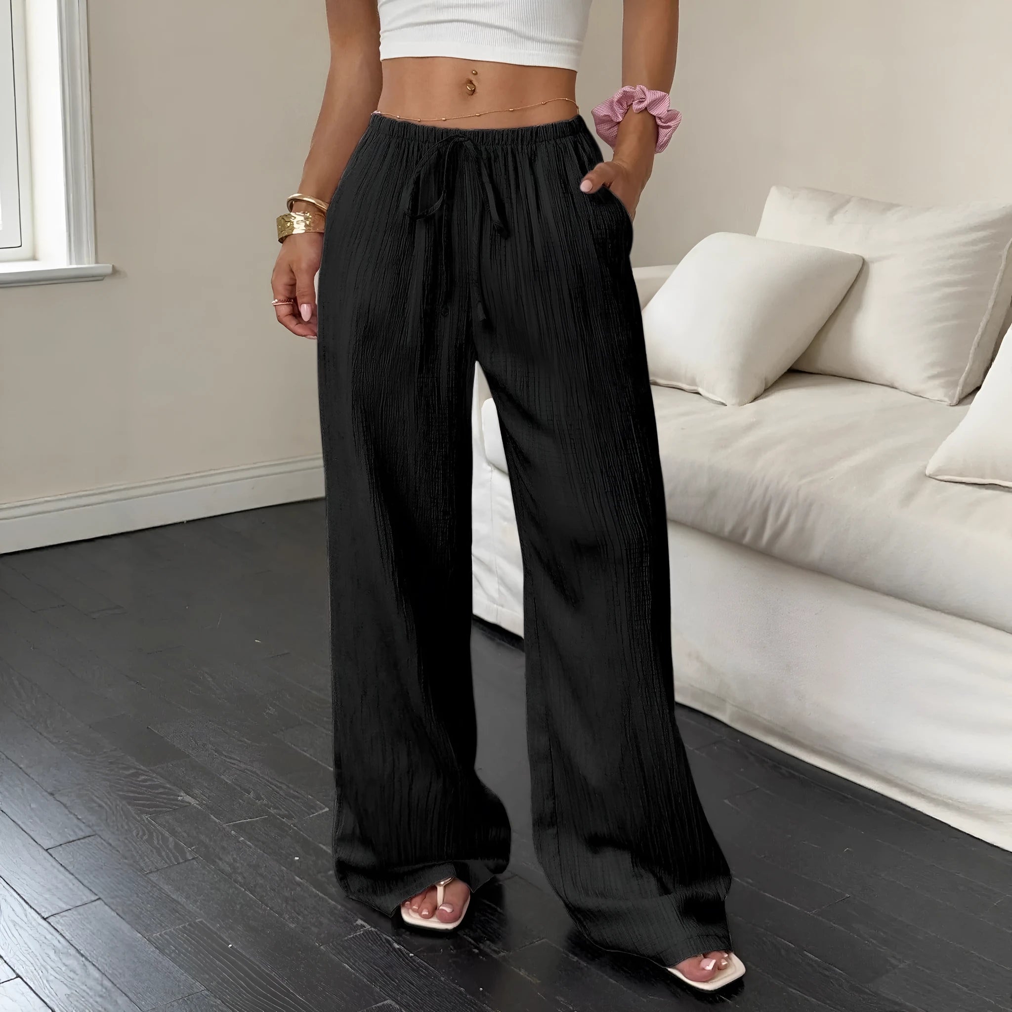 Women's black wide leg trousers with lace-up waist detail on hanger